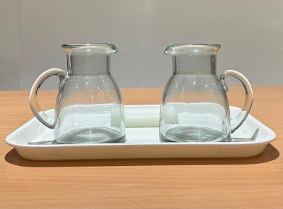 Montessori pouring activity with two clear glass pitchers for practical life