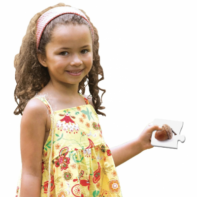 A girl holding a piece sequencing puzzle set with life cycles 